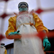 Medecins Sans Frontieres medical staff wearing protective clothing treat the body of an Ebola victim at their facility in Sierra Leone's Kailahun district on Aug. 14, 2014.
CARL DE SOUZA/AFP/Getty Images